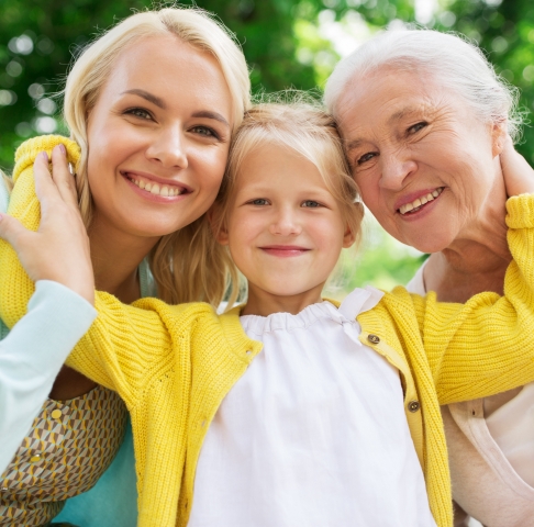 Three generations of women smiling after visiting their dentist in Jeffersonville