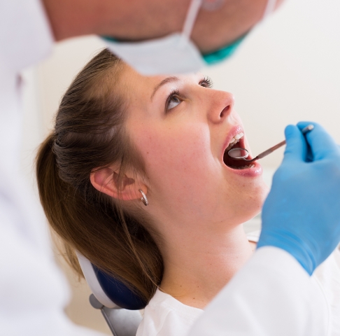 Dentist examining dental patient