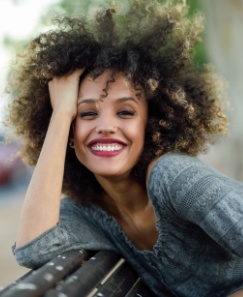 Woman sharing smile after replacing lost dental crown