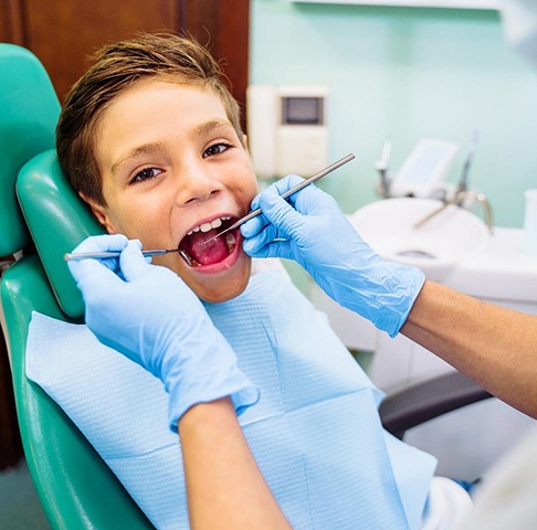 Young boy getting a fluoride treatment in Jeffersonville for baby teeth