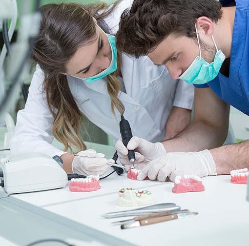 Dental student working on a model