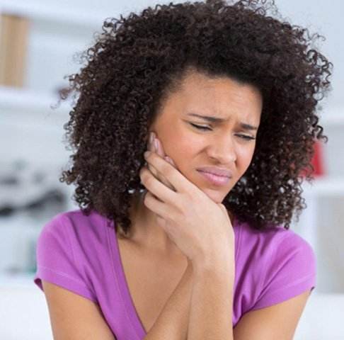 Woman with pain from teeth grinding in Jeffersonville