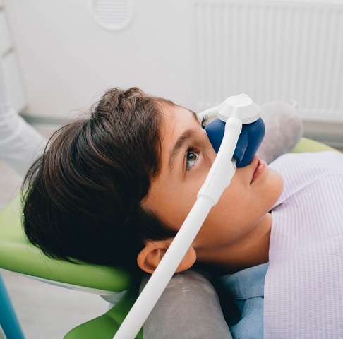 Child receiving nitrous oxide sedation dentistry treatment