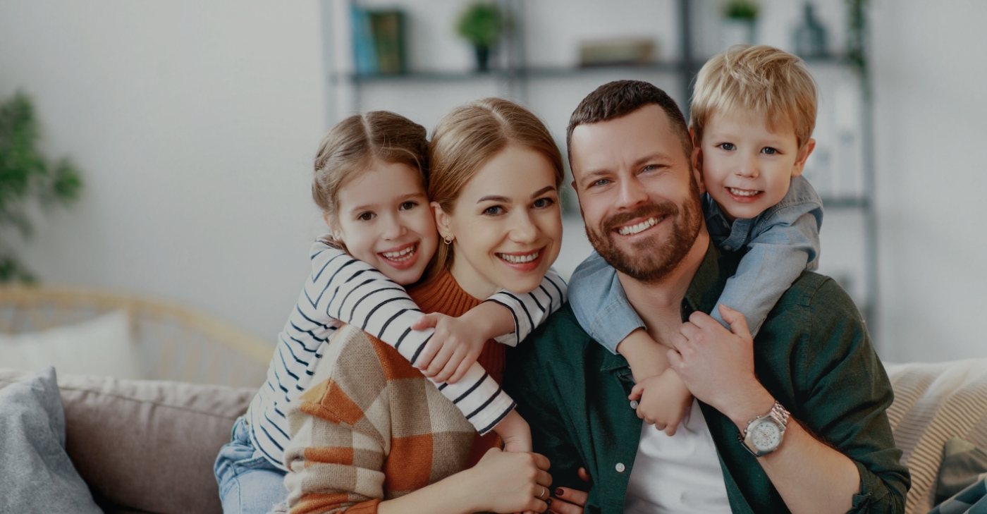 Family smiling after receiving dental services in Jeffersonville Indiana