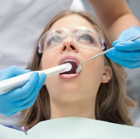 Dentist using intraoral camera to capture smile photos