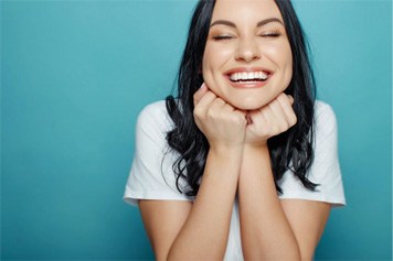 Woman smiling after getting veneers in Jeffersonville