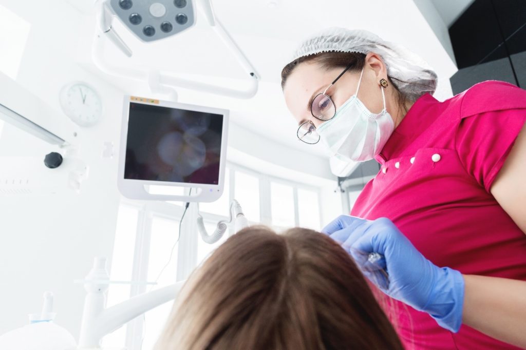 Closeup of dental assistant using an intraoral camera