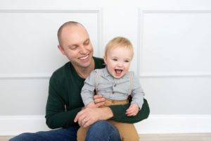 Dr. Eric R. Thornton of Limestone Dentistry smiling while holding his laughing toddler