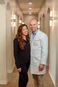 a dentist and hygienist smiling