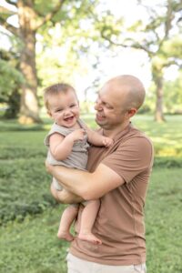 Limestone Dentistry's Dr. Thornton holding his smiling child outside